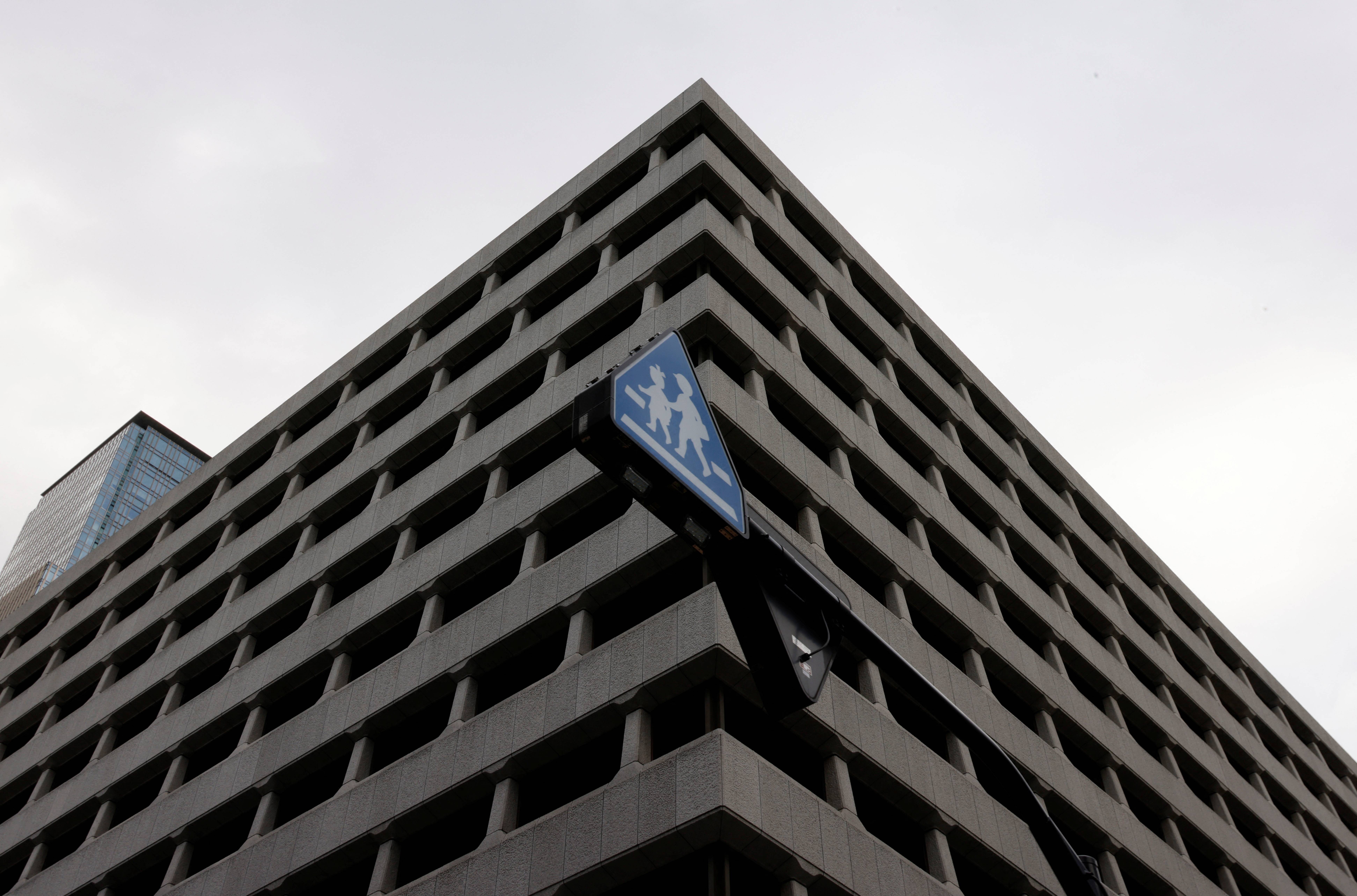 A traffic sign is seen in front of the headquarters of Bank of Japan in Tokyo