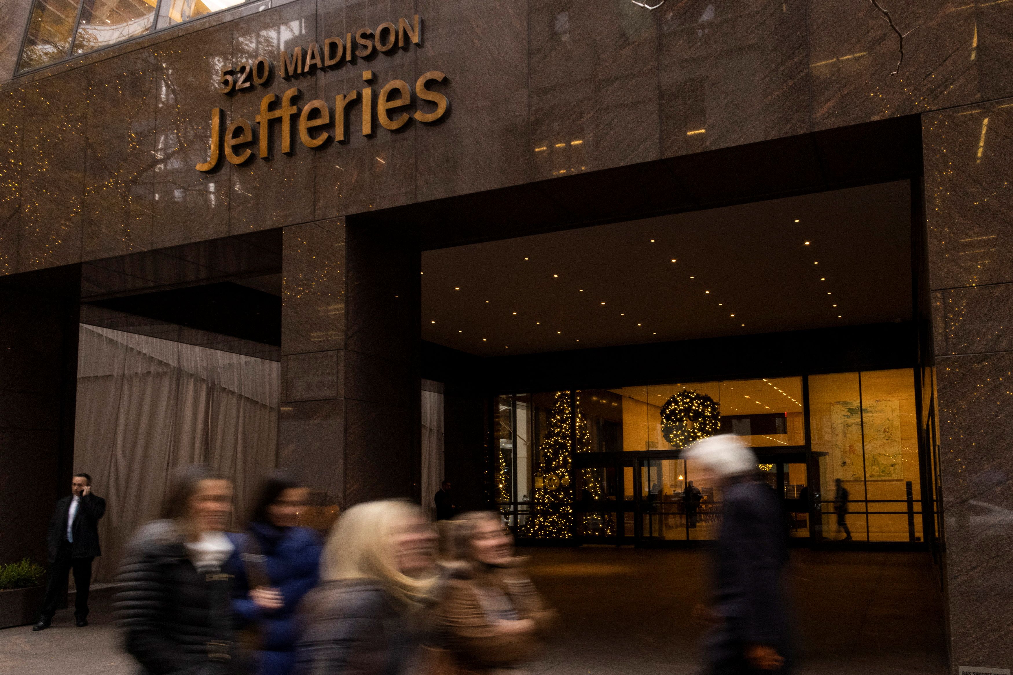 People walk outside of Jefferies Financial Group offices in Manhattan, New York