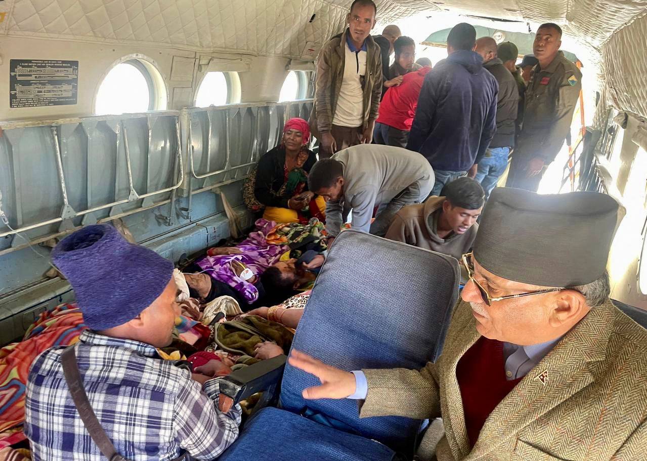Nepal Prime Minister, Pushpa Kamal Dahal speaks to rescued people inside a helicopter after an earthquake in Jajarkot
