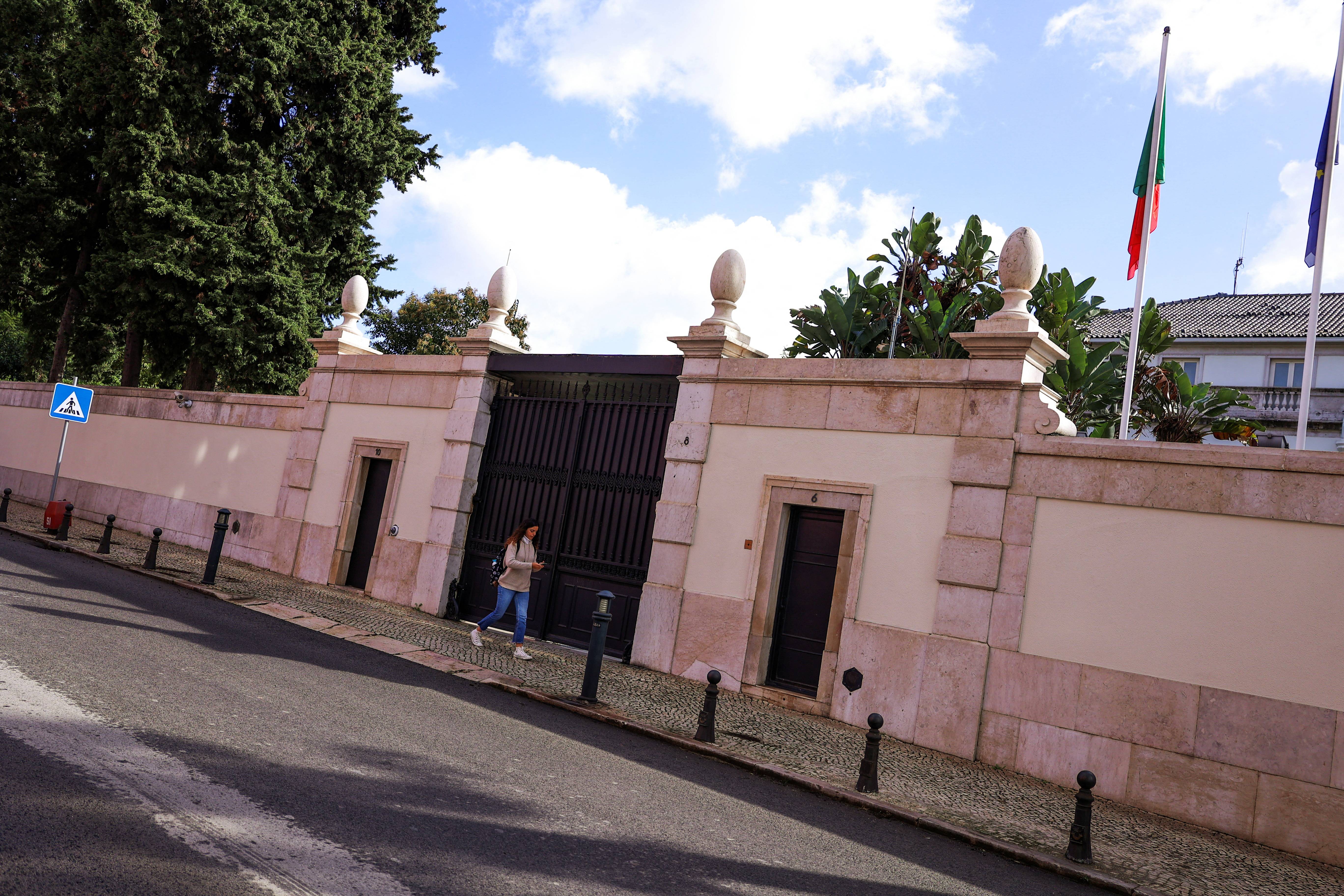 A woman passes the entrance of Portugal Prime Minister official redidence in Sao Bento Palace, Lisbon