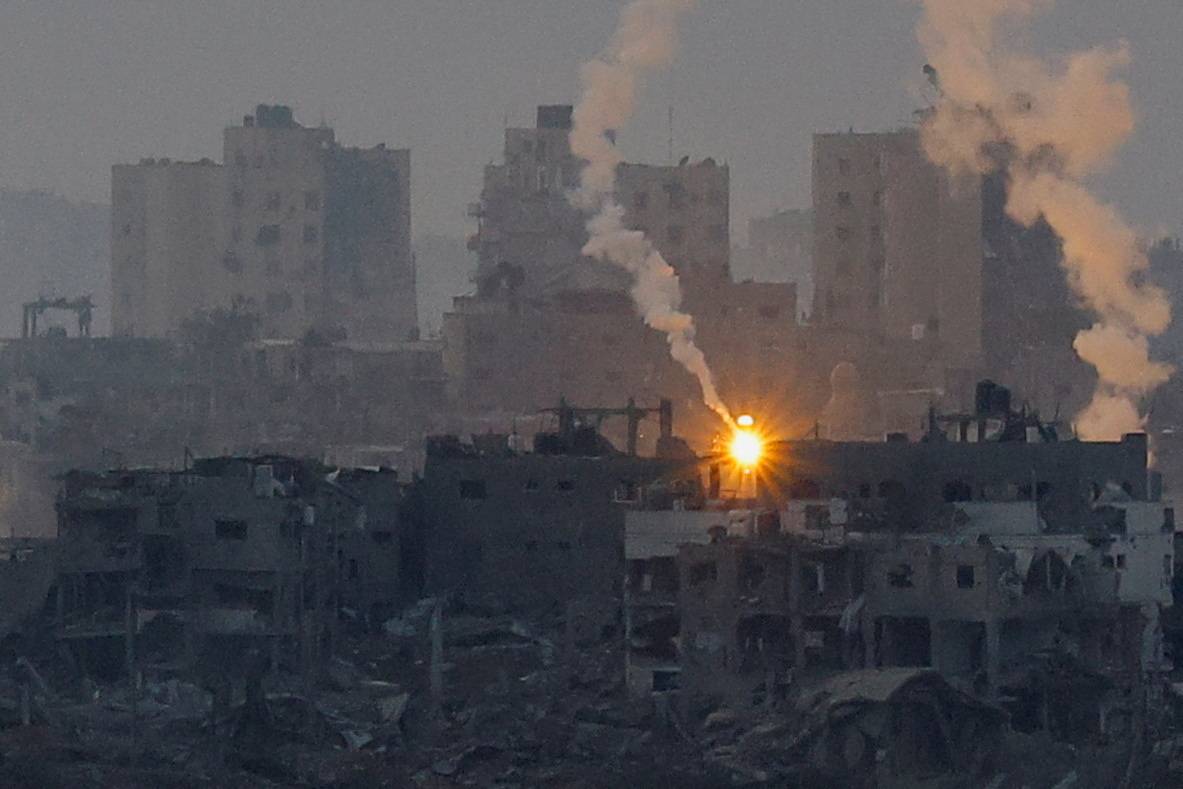 Flares burn above Gaza, as seen from southern Israel