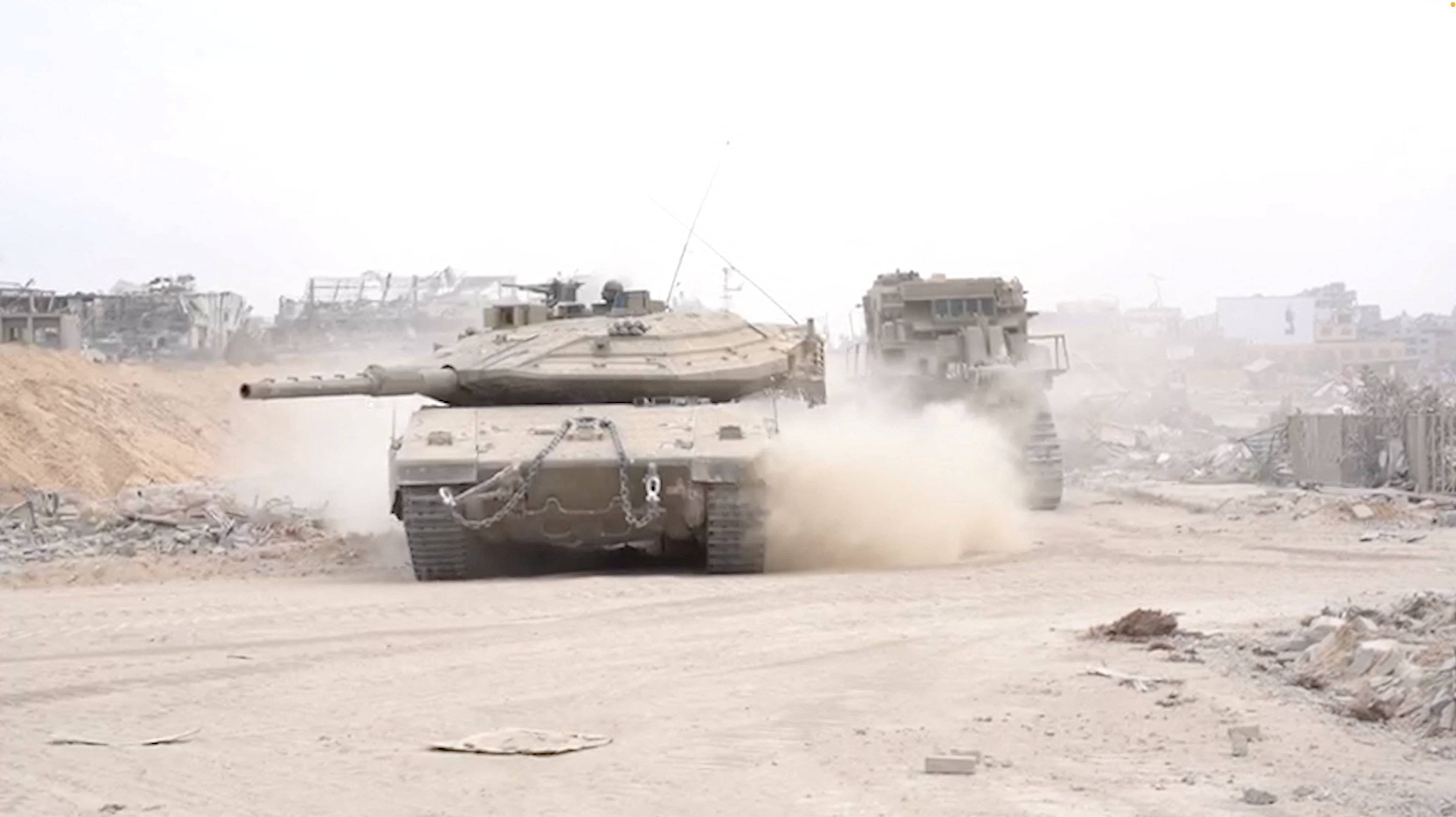 Israeli military vehicles operate amid what the Israeli army says is the ongoing ground operation against the Palestinian Islamist group Hamas, in a location given as Gaza