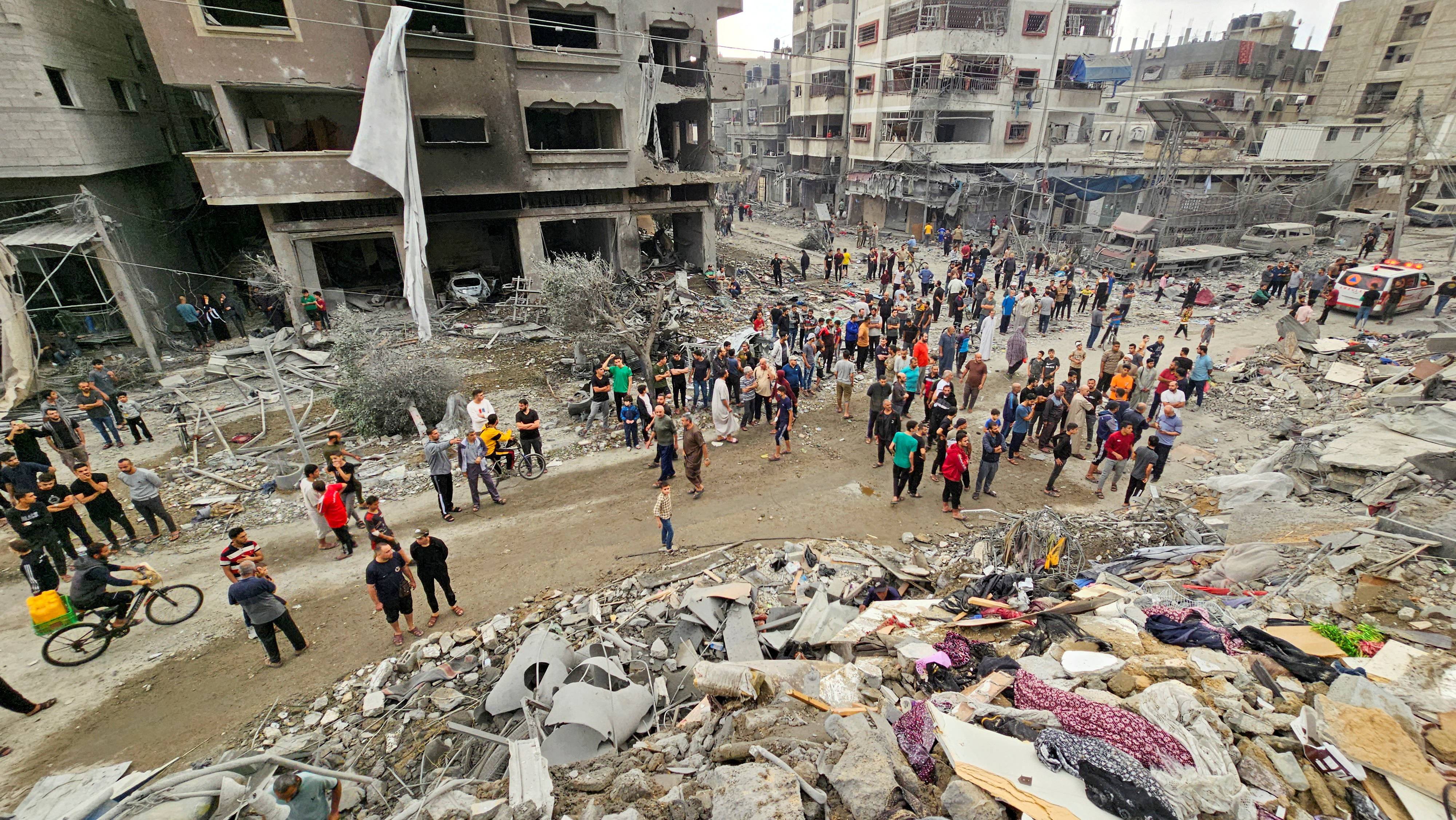 Palestinians inspect the site of Israeli strikes on houses in Jabalia refugee camp, in northern Gaza