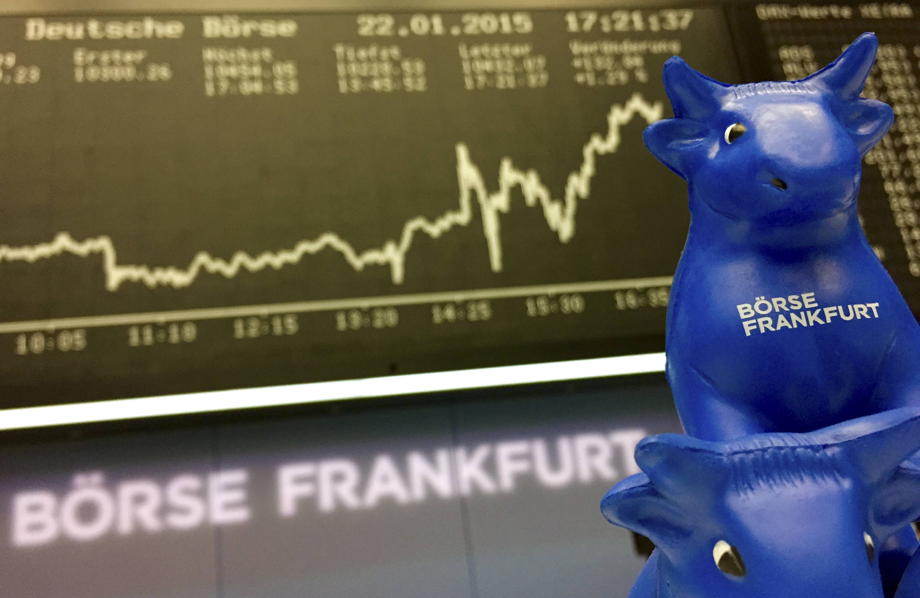 A plastic bull figurine, symbol of the Frankfurt stock exchange is pictured in front of the German share price index DAX board at the Frankfurt stock exchange